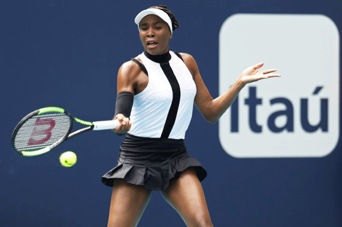 USA's Venus Williams hits a forehand against Slovenia's Dalila Jakupovic durng their first round match at the Miami Open at the Miami Open Tennis Complex in Miami, Florida