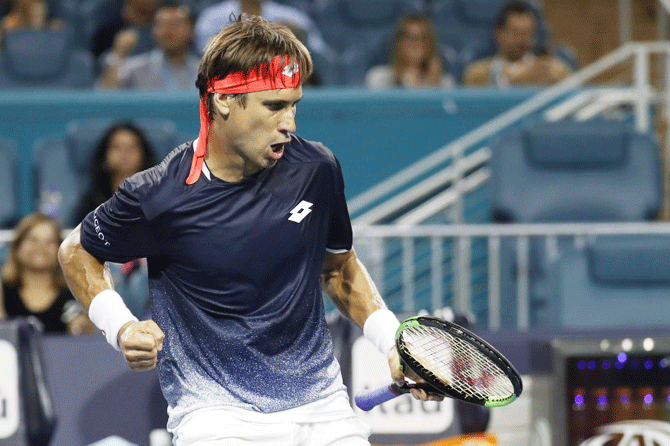 Spain's David Ferrer celebrates after winning a game against Germany's Alexander Zverev in the second round of the Miami Open at Miami Open Tennis Complex in Miami, Florida, on Sunday