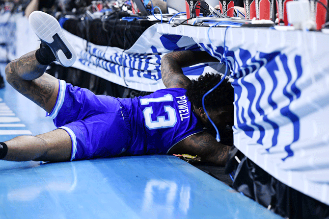 Seton Hall Pirates guard Myles Powell (13) slides into a table on the sidelines after saving the ball from going out of bounds against the Wofford Terriers during the second half in the first round of the 2019 NCAA Tournament at Jacksonville Veterans Memorial Arena in Jacksonville, Florida, on Thursday, Mar 21