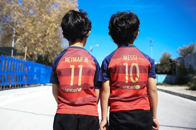 Refugee children wear Barcelona FC jersey shirts in Mytilene city, on the island of Lesbos, Greece 