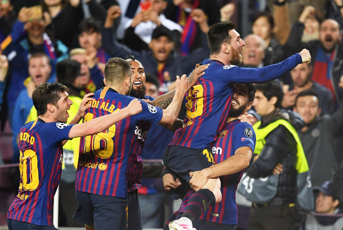 Barcelona players celebrate with captain Lionel Messi after scoring the second goal