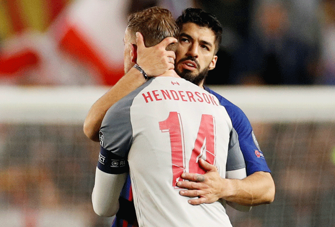 Barcelona's Luis Suarez and Liverpool's Jordan Henderson greet each other after the match