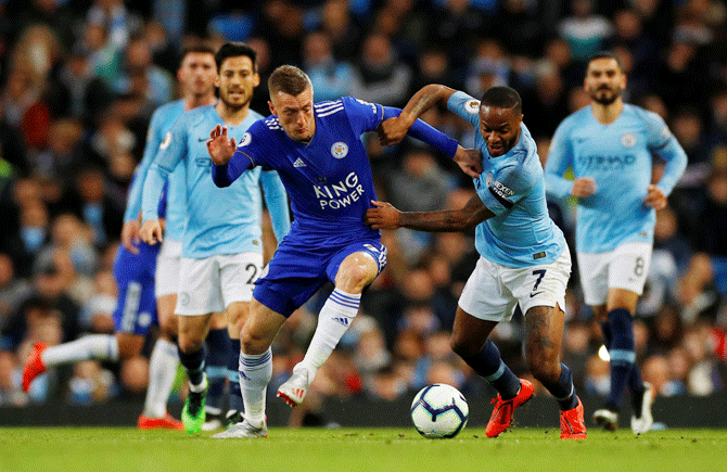Leicester City's Jamie Vardy is challenged by Manchester City's Raheem Sterling