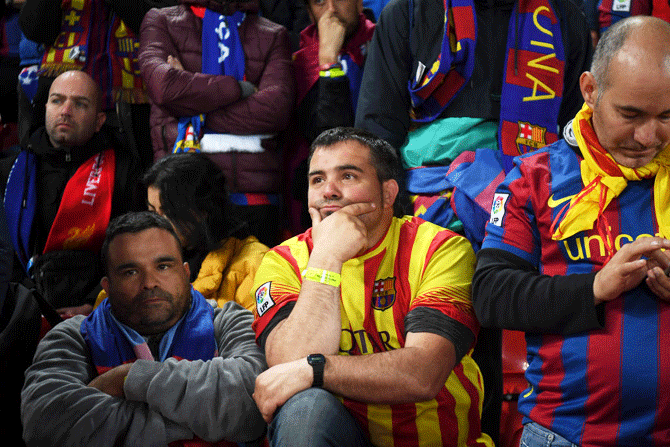 Barcelona fans look dejected in defeat after the UEFA Champions League semi-final second leg match against Liverpool at Anfield on Tuesday