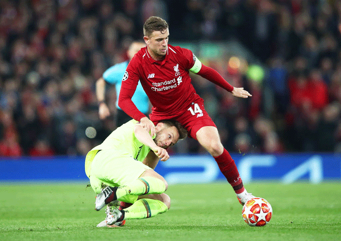 Barcelona's Ivan Rakitic challenges Liverpool captain Jordan Henderson during their UEFA Champions League semi-final second leg match at Anfield in Liverpool, on Wednesday