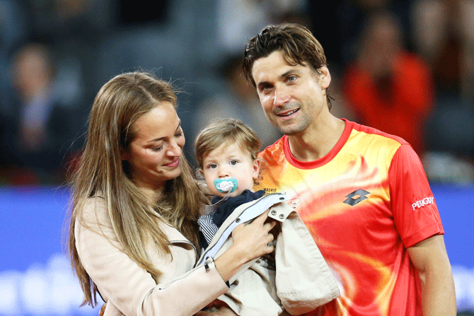 Spain's David Ferrer with his partner, Marta Tornel and son, Leo Ferrer during his farewell ceremony at the Madrid Open on Wednesday