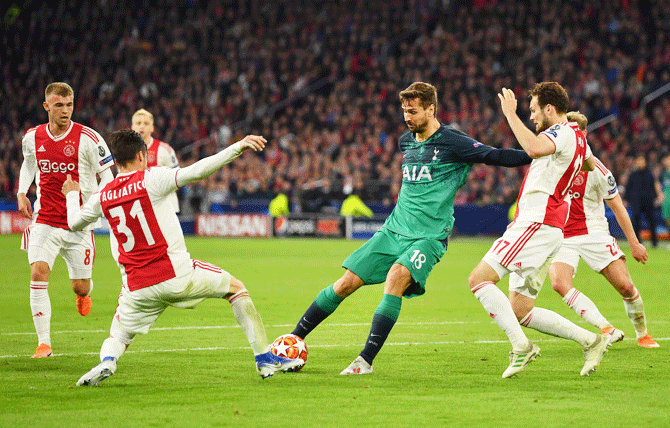 Ajax's Nicolas Tagliafico and Daley Blind battle for possession with Tottenham Hotspur's Fernando Llorente