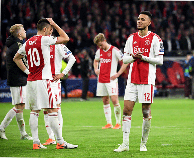 Ajax's Noussair Mazraoui looks dejected as he applauds the fans after the match