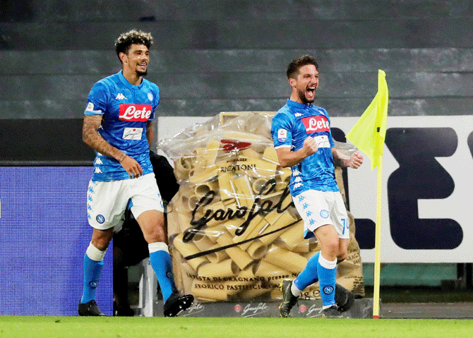 Napoli's Dries Mertens celebrates with teammat Kevin Malcuit after scoring their second goal against Inter Milan at Stadio San Paulo in Naples, Italy on Sunday