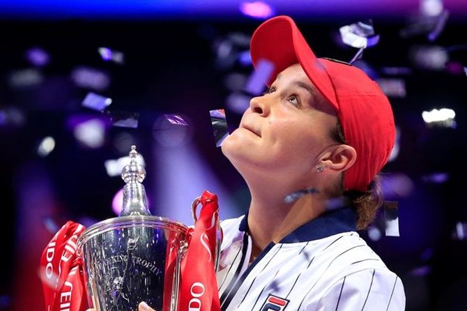 Australia's Ashleigh Barty poses with a trophy as she celebrates beating Ukraine's Elina Svitolina in the final WTA Finals in Shenzhen.