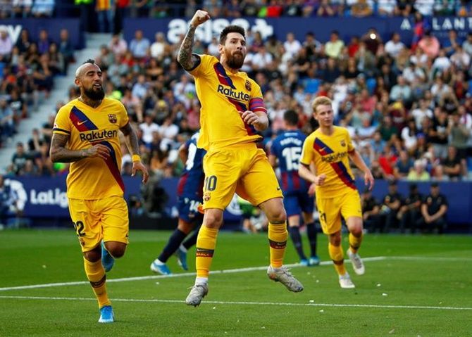 Lionel Messi celebrates putting Barcelona ahead from the penalty spot against Levante.