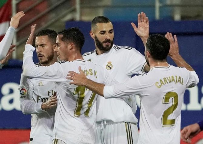 Karim Benzema celebrates scoring Real Madrid's third goal from the penalty spot 