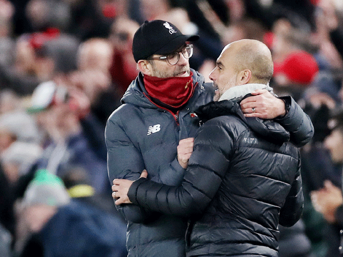 Liverpool manager Juergen Klopp greets Manchester City manager Pep Guardiola at the end of the match on Sunday