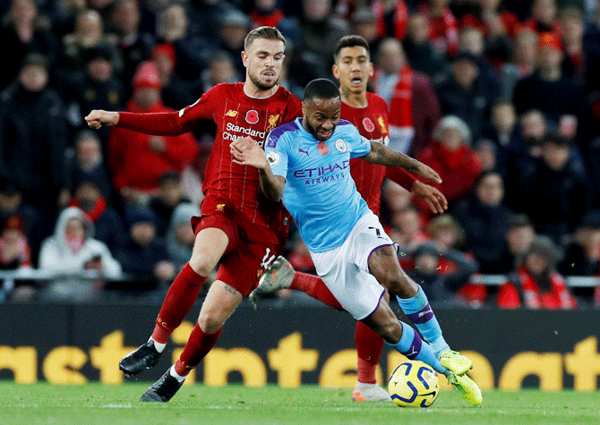 Manchester City's Raheem Sterling in action with Liverpool's Jordan Henderson