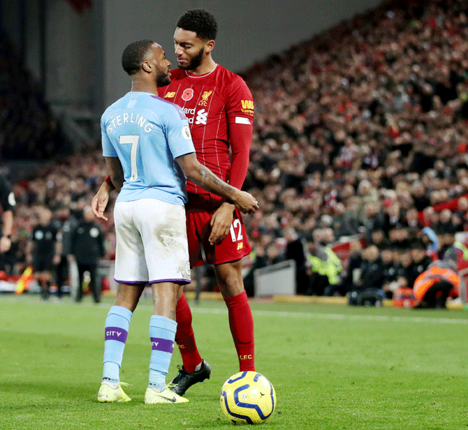 Liverpool's Joe Gomez and Manchester City's Raheem Sterling clash during their English Premier League match at Anfield in Liverpool on Sunday