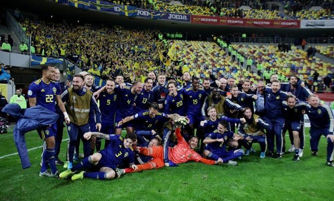 Sweden players celebrate after beating Romania and qualifying.