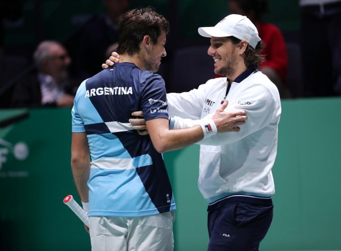 Argentina's Guido Pella celebrates with captain Gaston Gaudio after winning his Davis Cup match against Chile's Nicolas Jarry in Caja Magica, Madrid, on Tuesday