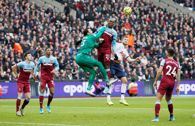 Tottenham Hotspur's Eric Dier in an aeriel challenge against West Ham United's Roberto and Angelo Ogbonna