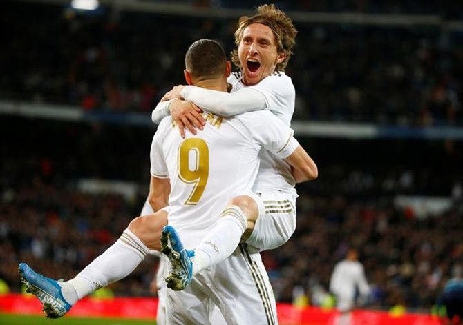 Luka Modric celebrates scoring Real Madrid's third goal with Karim Benzema in Saturday's La Liga match against Real Sociedad