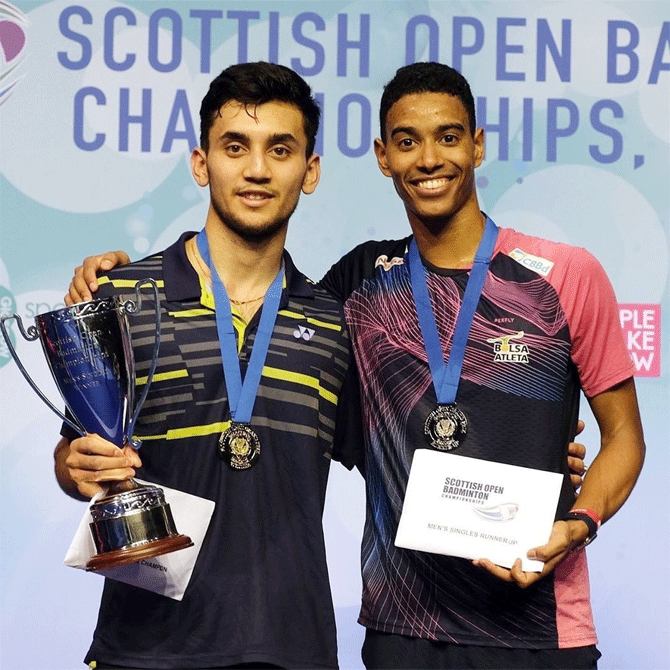 India's Lakshya Sen celebrates with the trophy alongside Brazil's Ygor Coelho after defeating the latter to win the Scottish Open title on Sunday