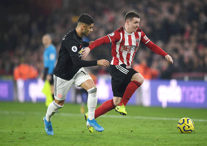 Sheffield United's John Fleck battles for possession with Manchester United's Andreas Pereira 
