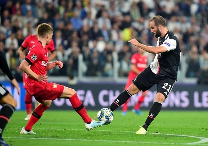 Juventus's Gonzalo Higuain shoots at goal during the match against Bayer Leverkusen.