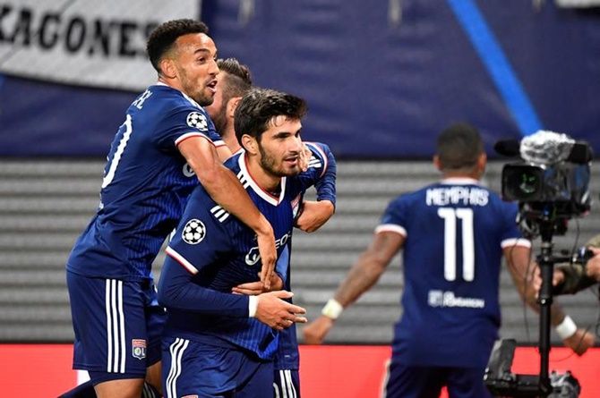 Martin Terrier celebrates is congratulated by teammates after scoring Olympique Lyonnais's second goal against Leipzig.