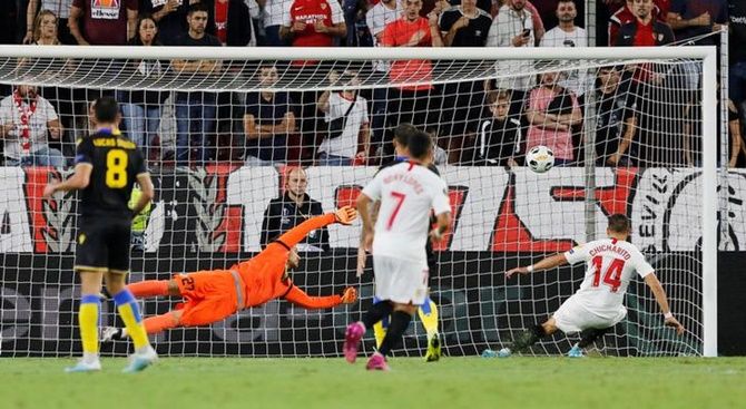 Javier Hernandez scores Sevilla's first goal against Apoel Nicosia in the Group A match.