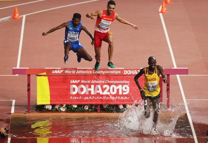 India's Avinash Sable, Spain's Ibrahim Ezzaydouni and Uganda's Benjamin Kiplagat battle it out during the men's 3000 metres Steeplechase heats.