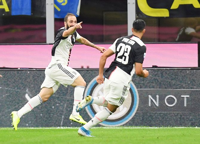 Juventus' Gonzalo Higuain celebrates scoring their second and winning goal against Inter Milan in their Seria A match at San Siro in Milan on Sunday