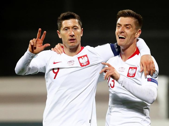 Robert Lewandowski celebrates scoring Poland's third goal.