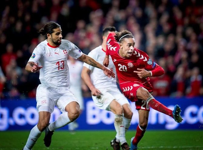 Switzerland's Ricardo Rodriguez fails to check Yussuf Poulsen, who scores the winning goal for Denmark.