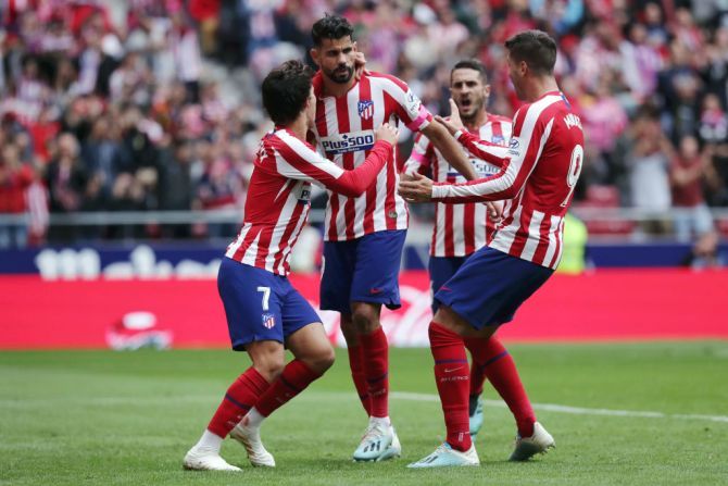 Atletico Madrid's celebrates with teammates after scoring his team's first goal against Club Atletico de Madrid in their La Liga match at Wanda Metropolitano in Madrid on Saturday