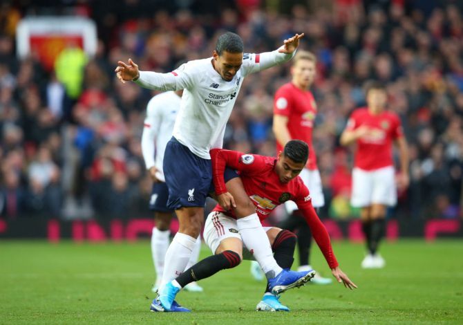 Liverpool's Virgil van Dijk and Manchester United's Andreas Pereira in action