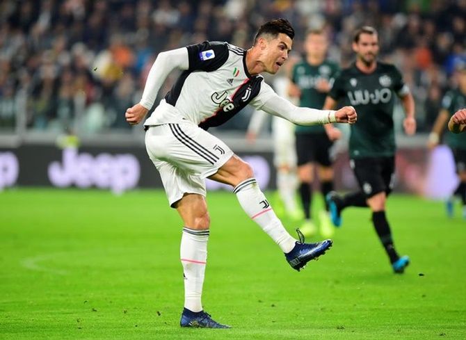 Cristiano Ronaldo scores Juventus's first goal against Bologna during Saturday's Serie A match at Allianz Stadium, in Turin, Italy.
