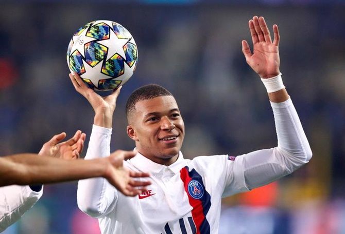 Kylian Mbappe celebrates after with the ball after Paris St Germain's victory over Club Brugge in the Champions League Group A match