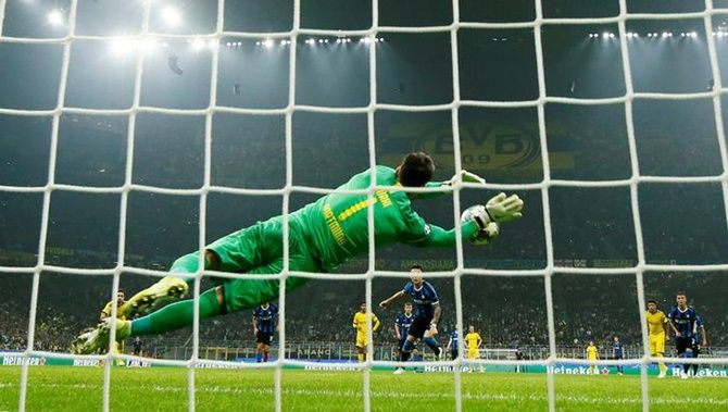 Borussia Dortmund's Roman Burki saves a penalty from Inter Milan's Lautaro Martinez