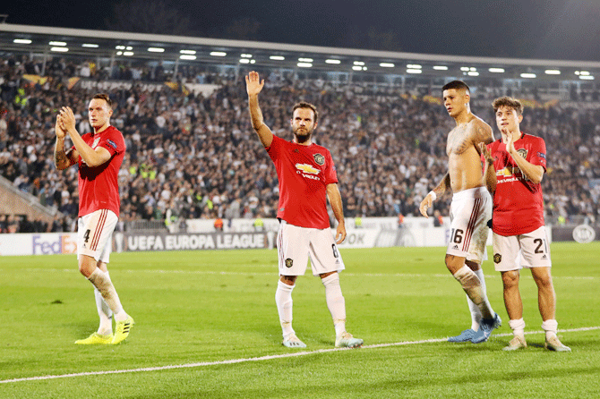 Manchester United's Phil Jones, Juan Mata, Marcos Rojo and Daniel James celebrate after the match against Partizan Belgrade in their Europa League Group L match at Partizan Stadium in Belgrade, Serbia, on Thursday