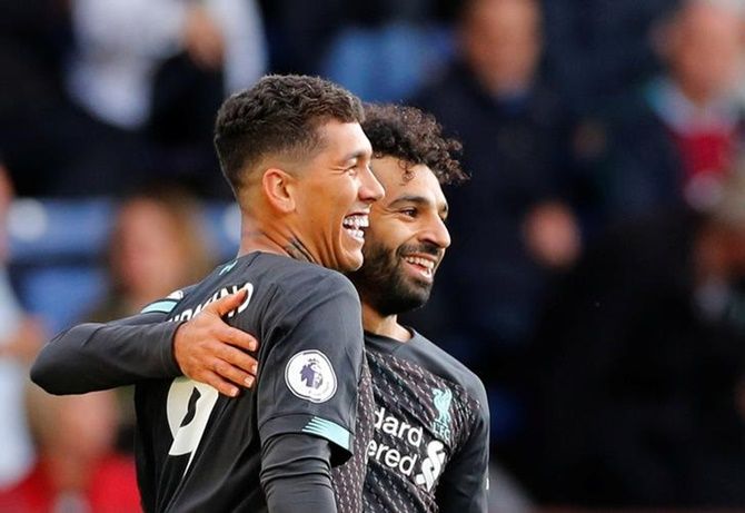 Roberto Firmino celebrates scoring Liverpool's third goal with Mohamed Salah during Saturday's Premier League match against Burnley