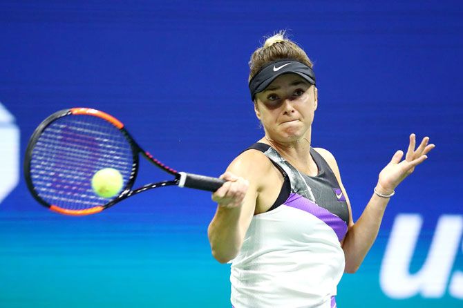 Elina Svitolina returns a shot during her semi-final match against Serena Williams