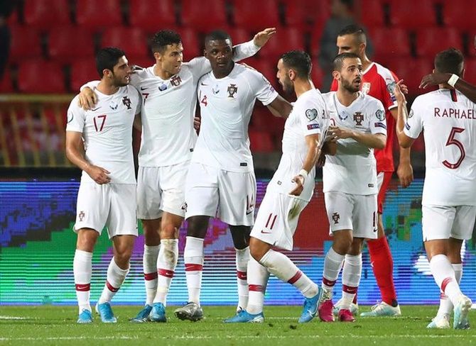 William Carvalho celebrates with Cristiano Ronaldo and teammates after scoring Portugal's first goal in the Euro 2020 Group B Qualifier against Serbia in Belgrade.