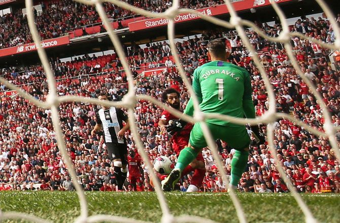 Liverpool's Mohamed Salah scores their third goal against Newcastle at Anfield on Sunday.