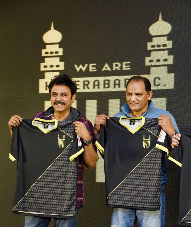 Former India cricket captain Mohammad Azharuddin (right) with Telugu actor Venkatesh Daggubati unveils the jersey of Hyderabad Football Club, in Hyderabad, on Sunday