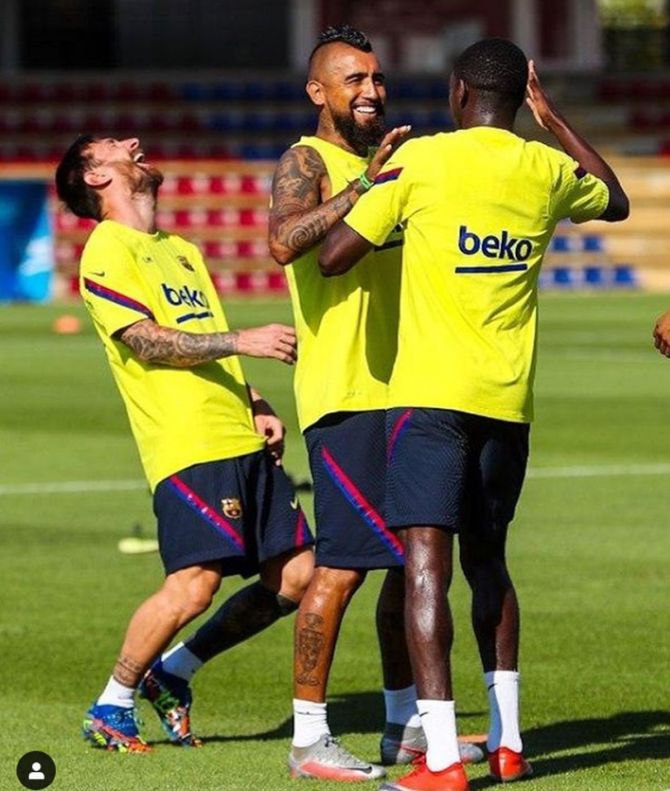 FC Barcelona's Lionel Messi, Arturo Vidal and Ousmane Dembele share a laugh during practice. The Catalans will be without the suspended Sergio Busquets and Arturo Vidal for the Napoli tie.