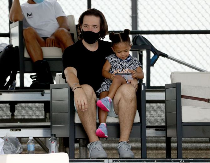 Serena Williams' husband and daughter, Alexis Ohanian and Alexis Olympia Ohanian watch the proceedings