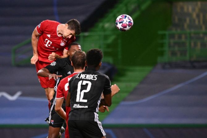 Bayern Munich's Robert Lewandowski heads to score the third goal