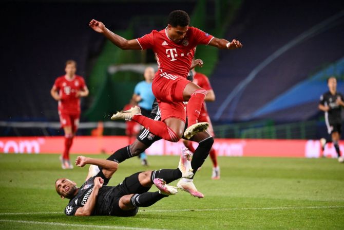 Olympique Lyonnais' Marcal challenges Bayern Munich's Serge Gnabry 