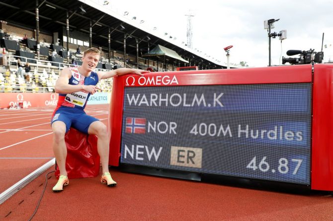 Norway's Karsten Warholm shows off the results board after winning in 400 Meters Hurdles at the Diamond League in Stockholm Olympic Stadium in Stockholm, Sweden, on Sunday