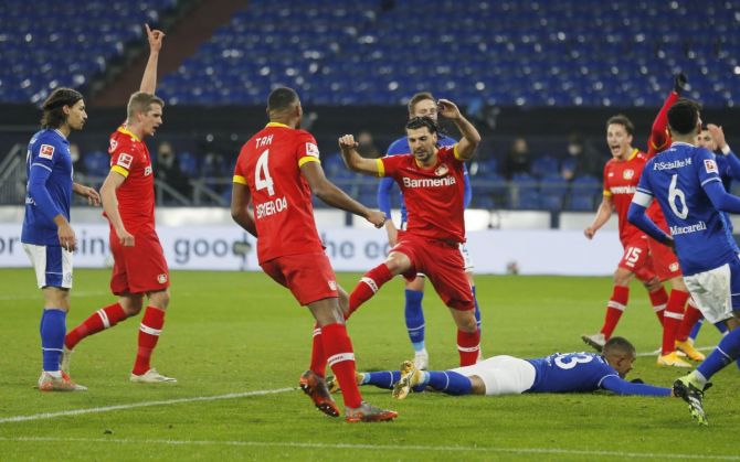 Bayer Leverkusen's Aleksandar Dragovic and teammates celebrate after Schalke 04's Malick Thiaw scores an own goal 