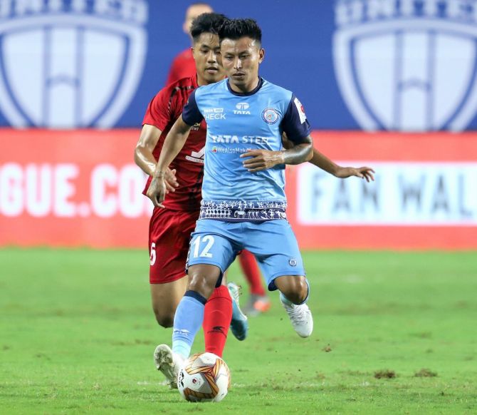 Jamshedpur FC's Jackichand Singh in action against a NorthEast United FC player during their ISL match at Vasco in Goa on Friday.